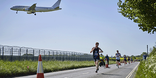 A photo of a charity marathon on the perimeter of London Gatwick's airfield