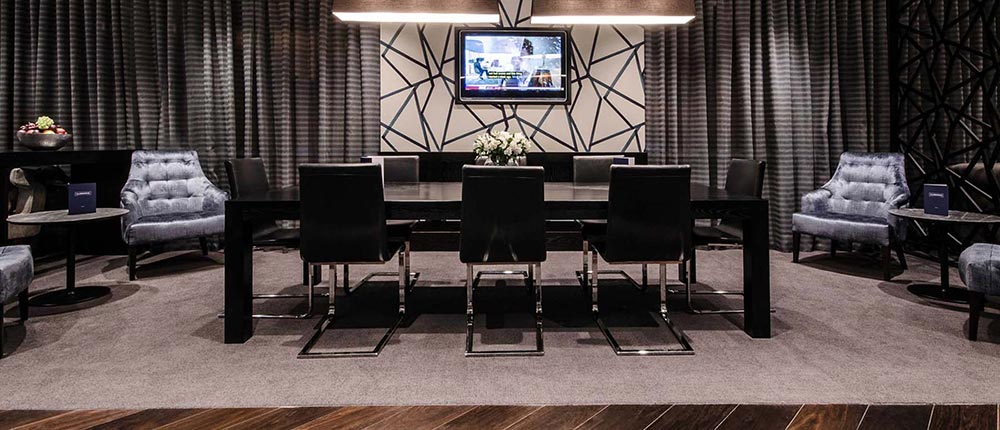 One of the seating areas in Clubrooms, gathered around a large on-wall TV