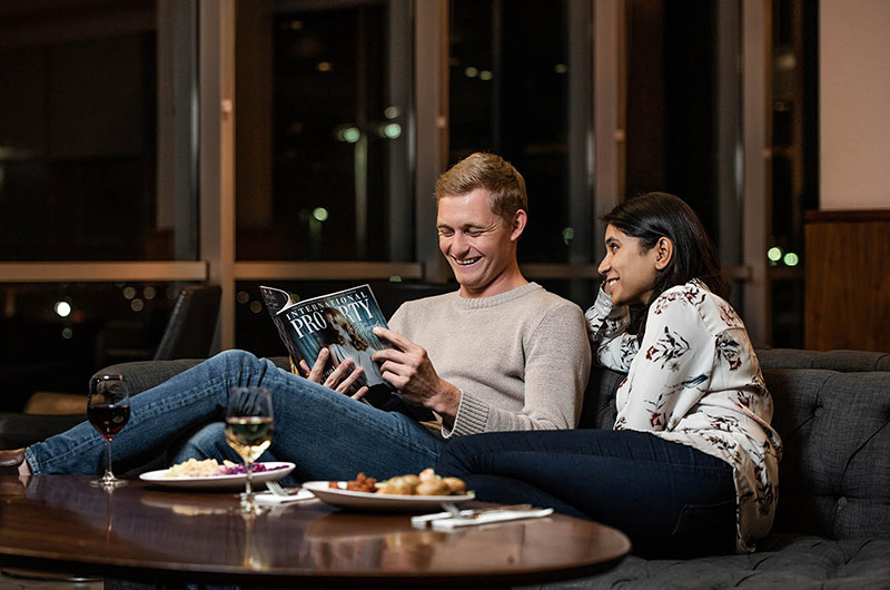 Horseshoe shaped bar surrounded by seating inside No 1 Traveller Lounge at Gatwick Airport.