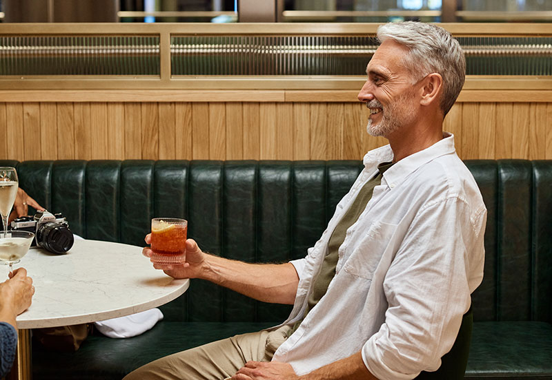 Image showing passenger relaxing with a drink in a bar at London Gatwick.