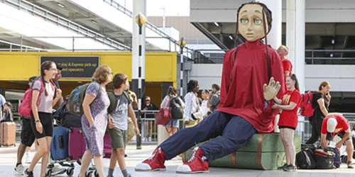image of a gigantic Auras Odyssey puppet on the Gatwick south terminal entrance