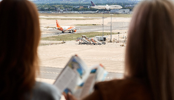 Image showing passengers looking out at the airfield before their flight after getting through security quickly