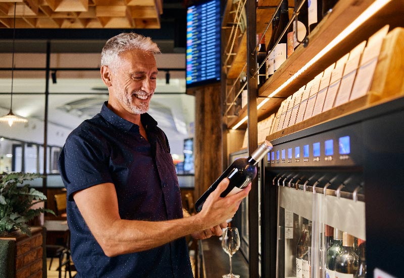 Image showing passenger perusing the vast wine options in Vagabond Bar & Kitchen in London Gatwick South Terminal