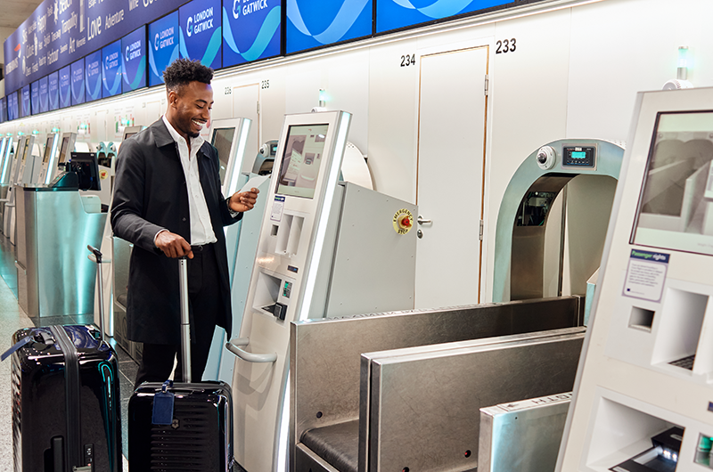 Passenger using self service bag drop