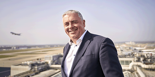 A photo of London Gatwick CEO Stewart Wingate smiling with the airfield in the backdrop