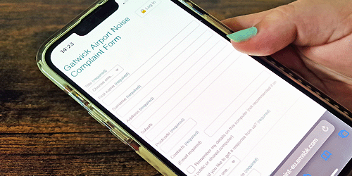 photo of a mobile phone displaying the Gatwick noise complaint form