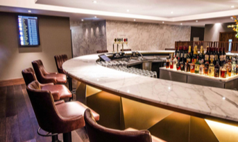 Seats around a bar in one of Gatwick Airport's lounges