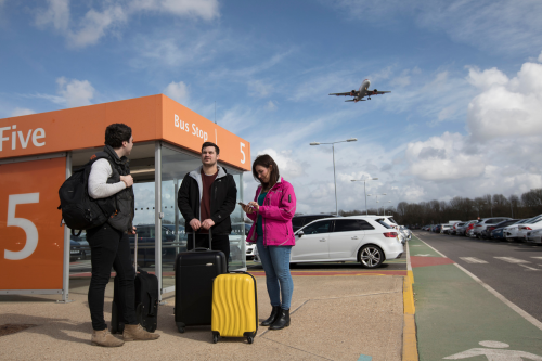 Passengers waiting for a bus at Long Stay which arrive every 7 - 12 minutes