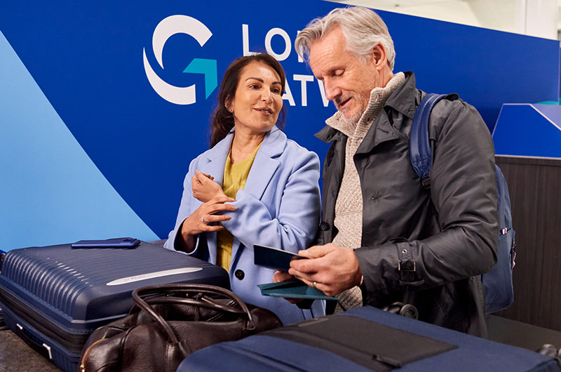 Image showing passengers using the branded preparation area at London Gatwick security