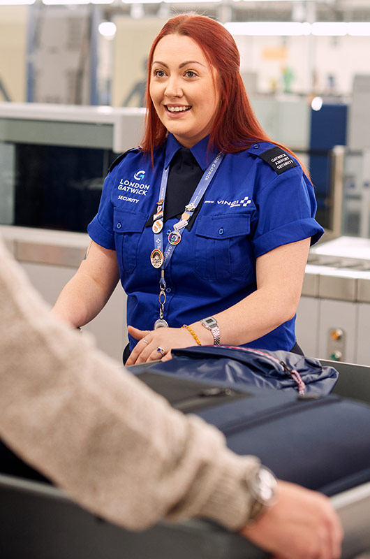 Image showing friendly security officer interacting with passenger