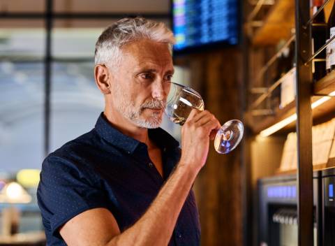 Someone tasting wine at London Gatwick