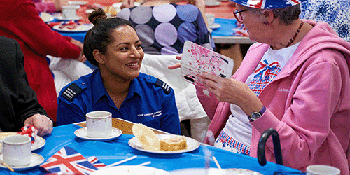 photo of a London Gatwick security officer talking with an elderly woman at a Gatwick community outreach event