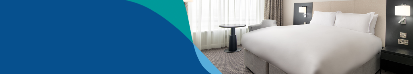 Banner image showing bed in hotel room at London Gatwick