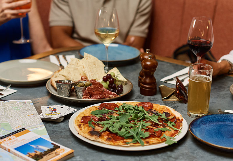 Delicious meal on table in a restaurant at London Gatwick with passengers relaxing and having a bite to eat before their flight