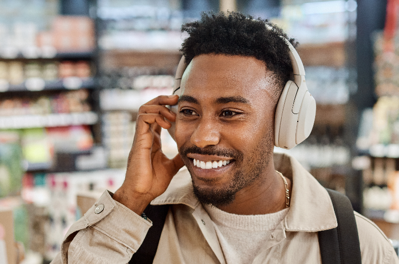 A man enjoying a shopping experience at London Gatwick, purchasing headphones