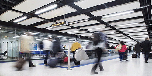 Long exposure photograph of passengers walking through London Gatwick airport's South terminal