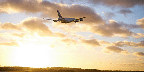 a photo of an Emirates a380 taking off into a dramatic sunset at London Gatwick