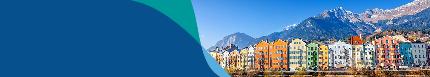 Colourful row of houses in front of mountains in Innsbruck 