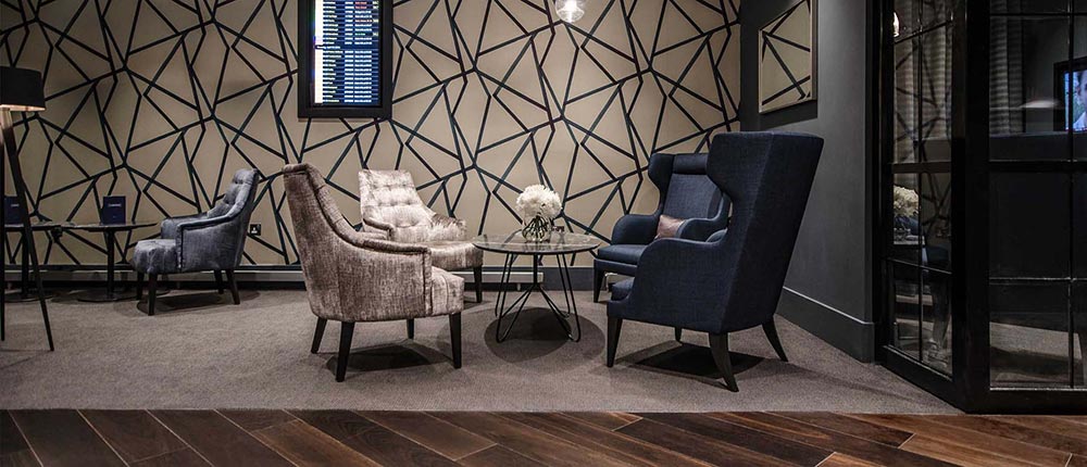 Beautiful, comfortable wing-back chairs facing each other in Gatwick Airport's Clubrooms