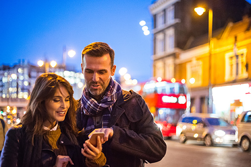 A couple enjoying a night out in London knowing their car is safely parked with Official Gatwick Airport Parking