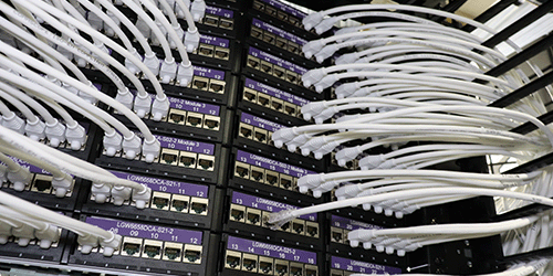 Closeup photo of servers at London Gatwick, with lots of neatly arranged cables