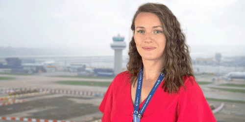 Profile headshot of Charlotte Dawson with the airfield and control tower in the background