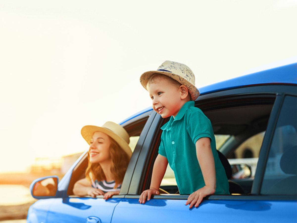 A child looking out of a car hire window