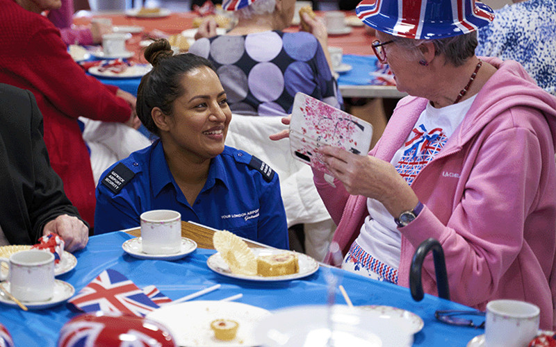 photo of a London Gatwick security officer talking with an elderly woman at a Gatwick community outreach event