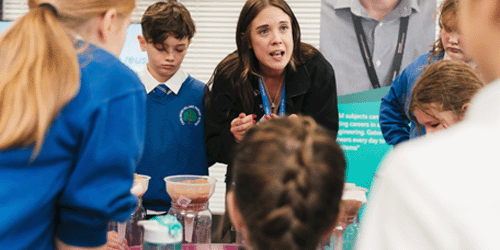 a photo of several Gatwick graduate scheme students along with Gatwick's apprentice development lead Dave White standing on the roof of the pier 6 bridge