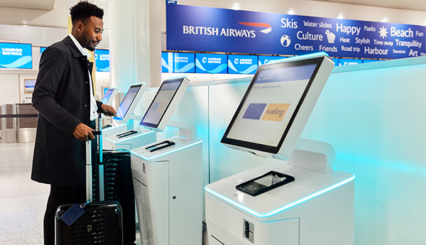 Image showing passenger using the self service check-in terminals in London Gatwick